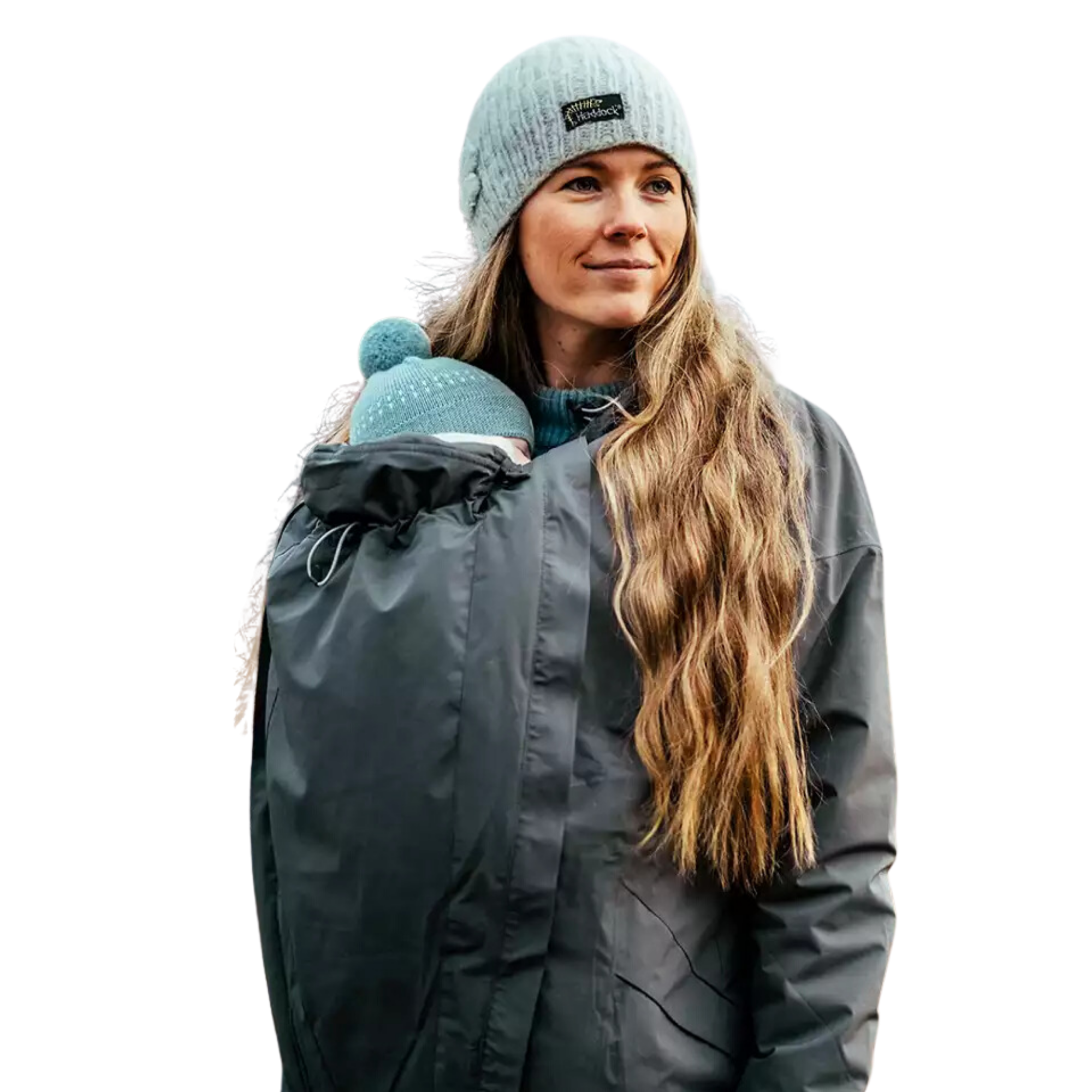  A mother wearing a black Mamalila babywearing jacket, carrying her baby in an integrated carrier. Both are cozy and protected in the fall outdoors, highlighting the jacket’s stylish design, warmth, and versatility for babywearing in cooler weather.