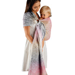 Woman wearring baby in a colorful ring sling