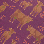 Pattern of brown cows with green tags on a purple background