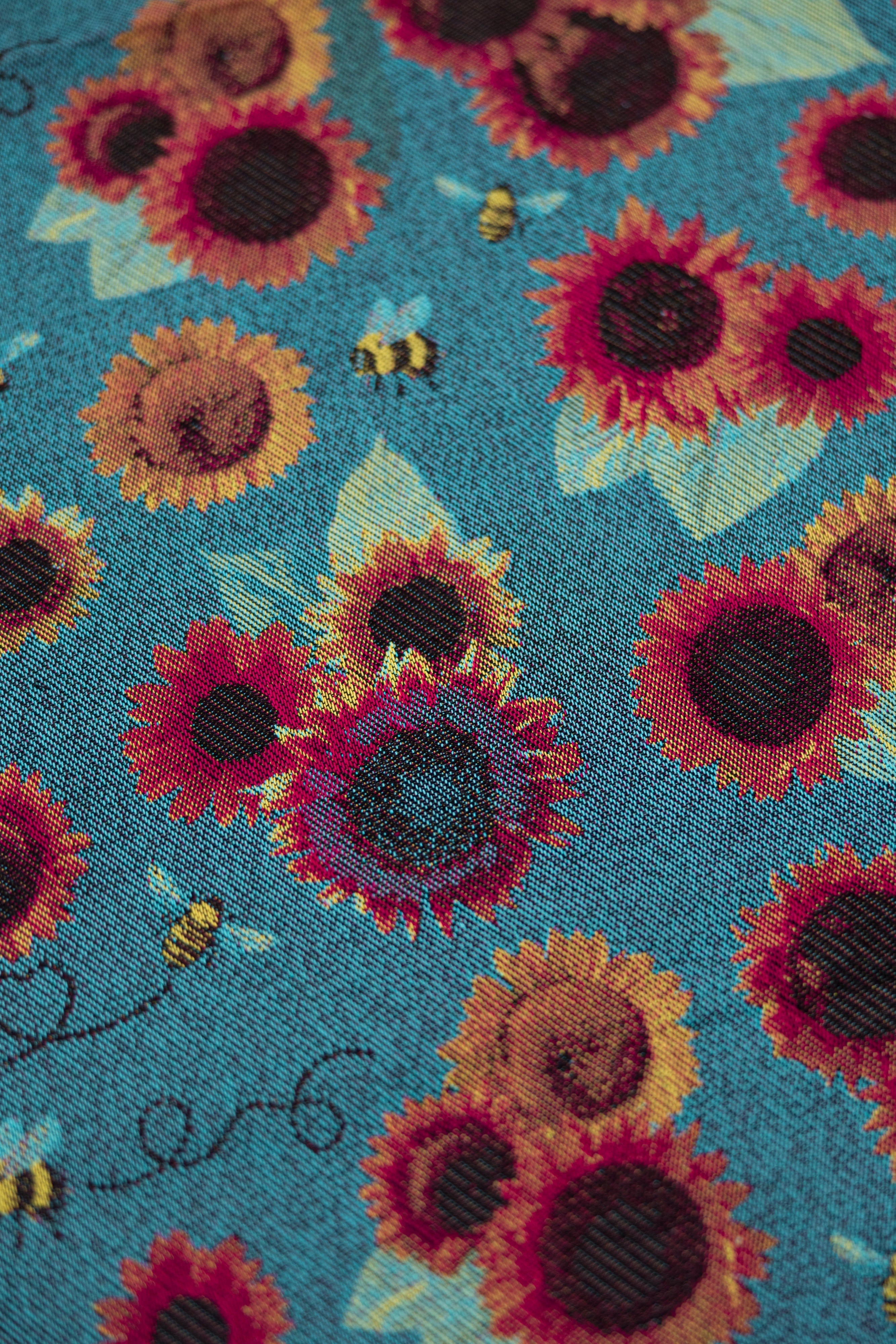 Decorative pattern with stylized figures and foliage and skulls on a orange background