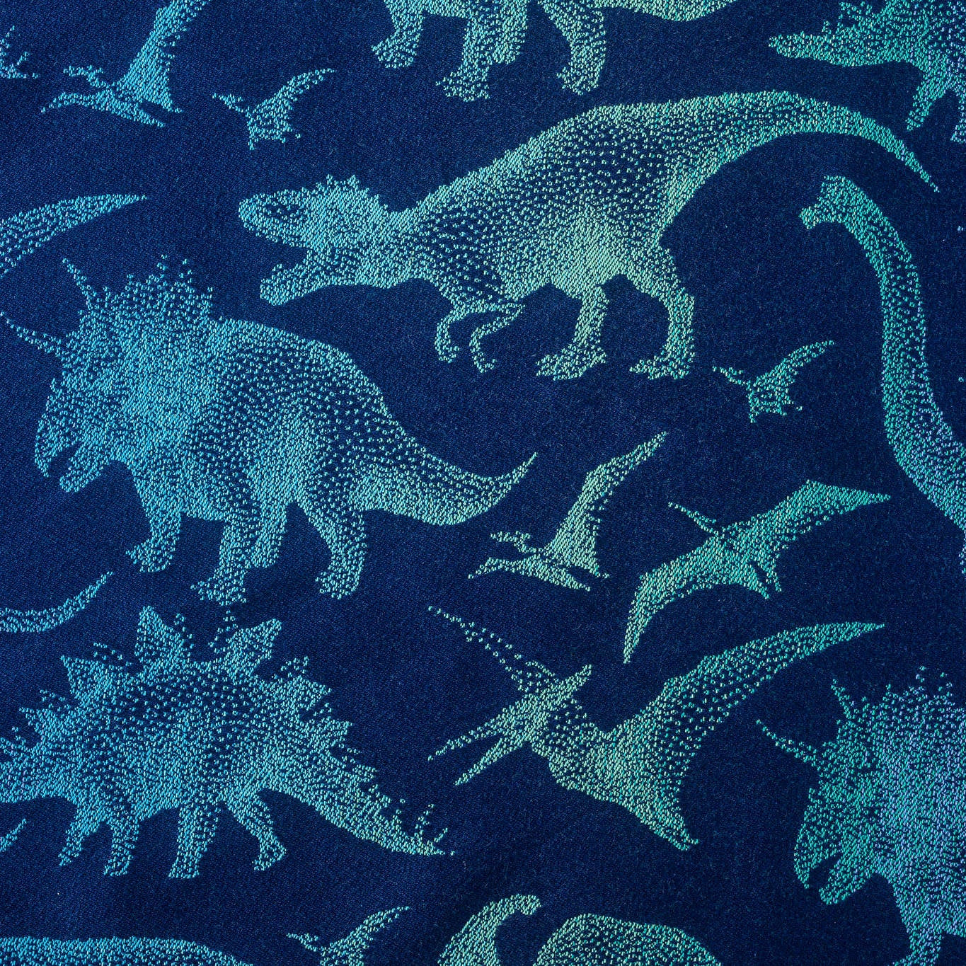 Pattern of blue dinosaurs on a dark blue background