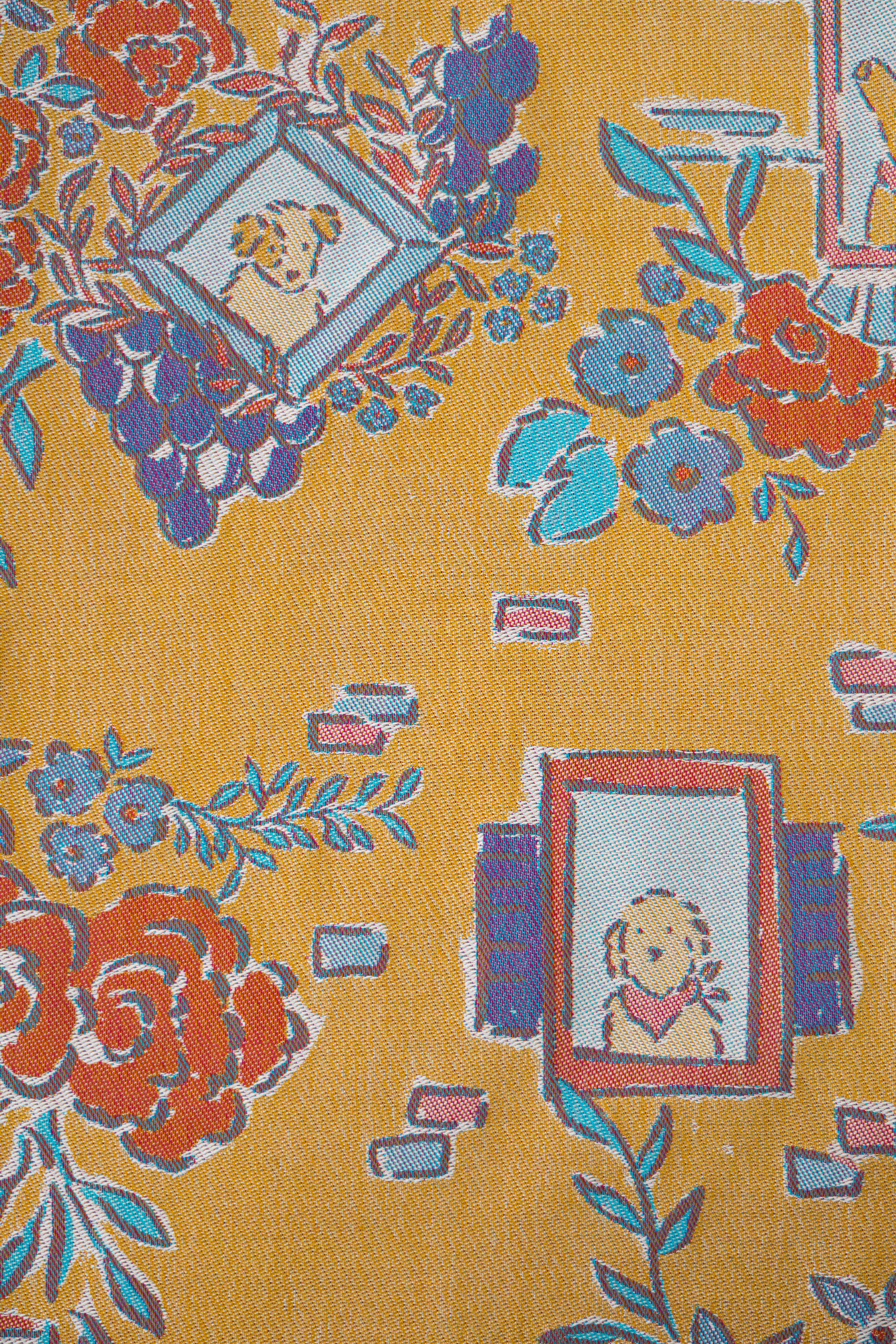 Floral and decorative pattern with dog illustrations on a yellow background