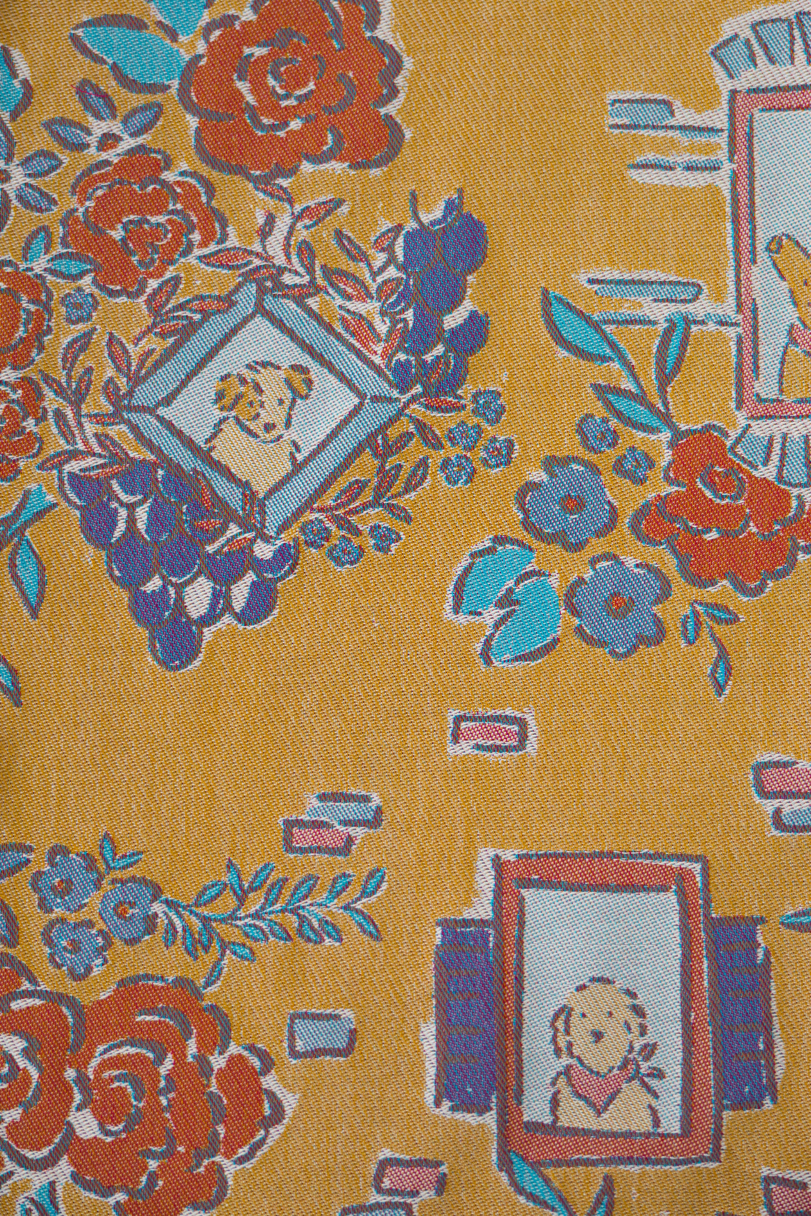 Floral and decorative pattern with dog illustrations on a yellow background