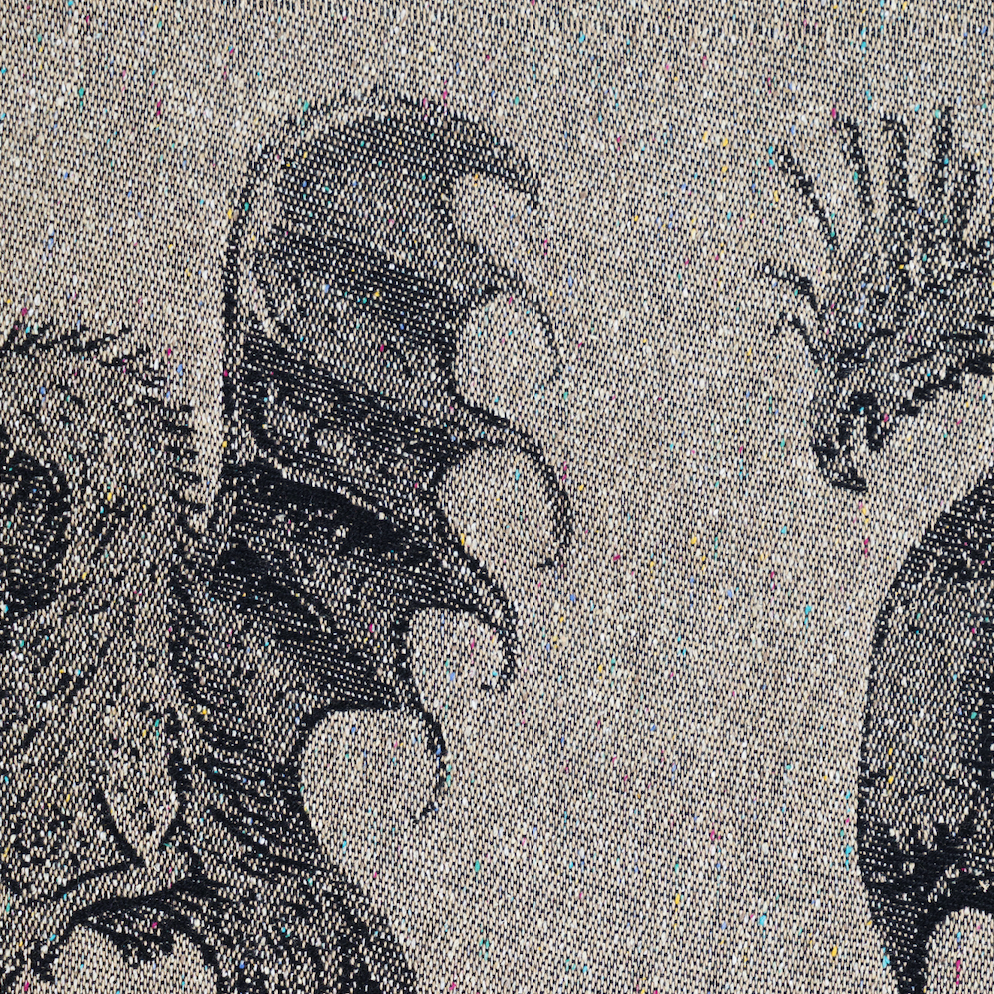Close-up of a woven textile pattern featuring black and white dragon  antasy creature illustrations on a white background.