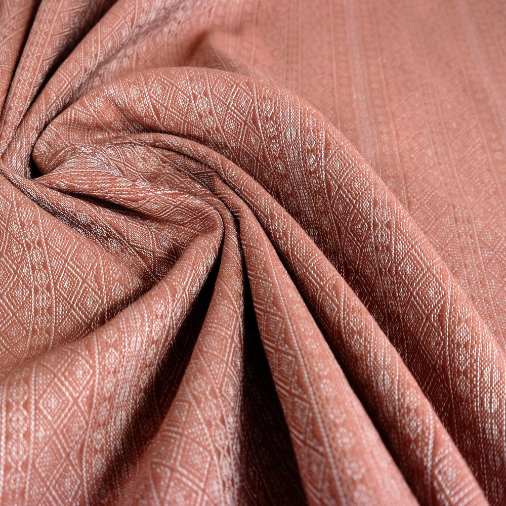 Prima Rosewood by Didymos, fabric swirled to show the drape and texture