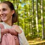 Prima Rosewood Woven Wrap by Didymos, parent carrying a baby on her back in the woods