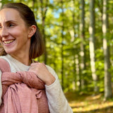 Prima Rosewood Woven Wrap by Didymos, parent carrying a baby on her back in the woods