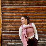 Prima Rosewood Woven Wrap by Didymos, full length front carry against a wooden wall