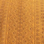 Close-up of a textured brown fabric with geometric pattern