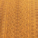 Close-up of a textured brown fabric with geometric pattern