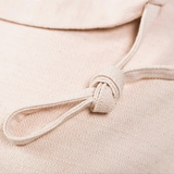 Close-up of a pink-beige fabric with a knot detail