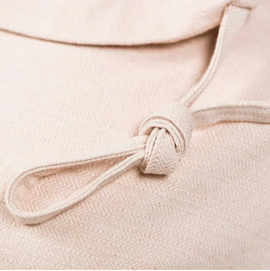 Close-up of a pink-beige fabric with a knot detail