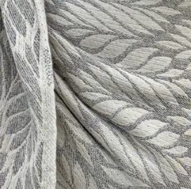 Close-up of textured fabric with a leaf pattern in gray tones